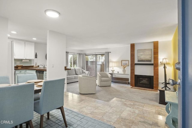 carpeted living room with a fireplace