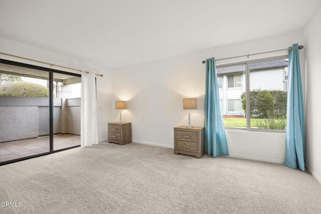 unfurnished bedroom with a closet, light colored carpet, and multiple windows