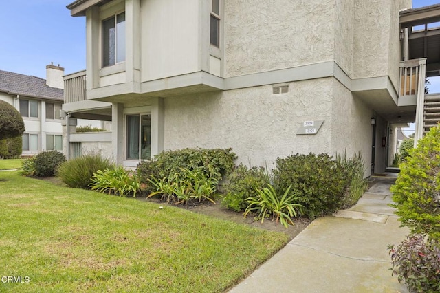 view of property exterior with a yard