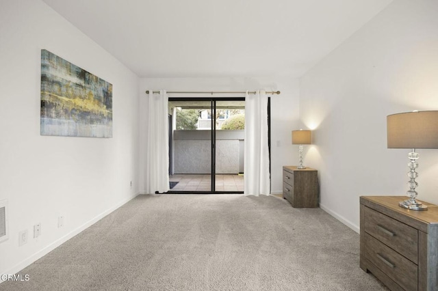 unfurnished room with light carpet