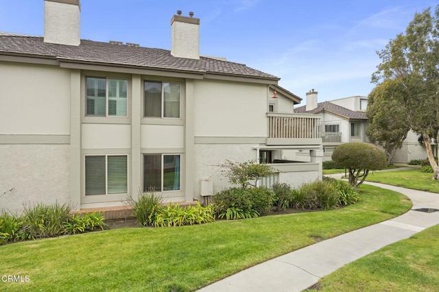 view of property exterior featuring a lawn