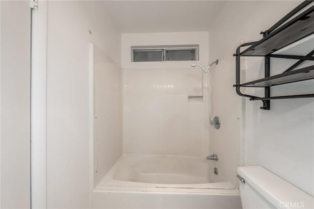 bathroom with bathing tub / shower combination and toilet