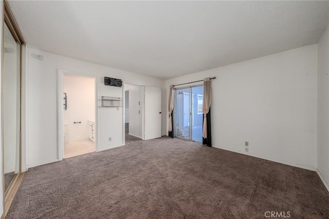 unfurnished bedroom featuring carpet flooring and ensuite bath