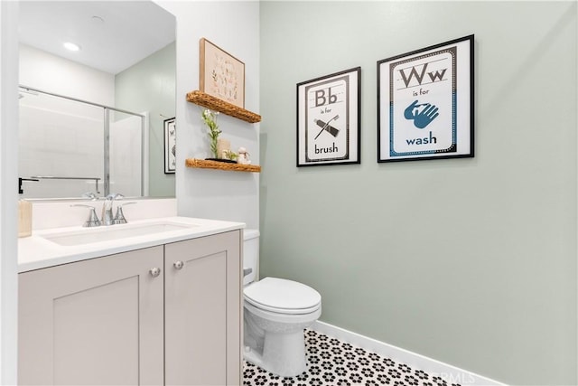 bathroom with a shower with door, vanity, and toilet