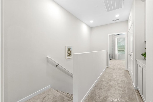 hallway with light colored carpet