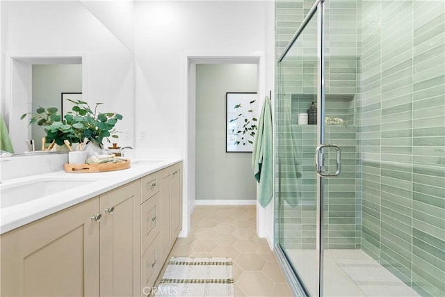 bathroom featuring tile patterned floors, vanity, and a shower with door