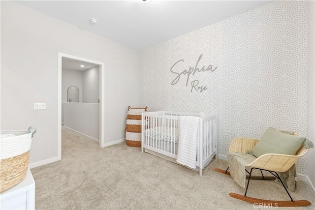 bedroom with light colored carpet and a crib