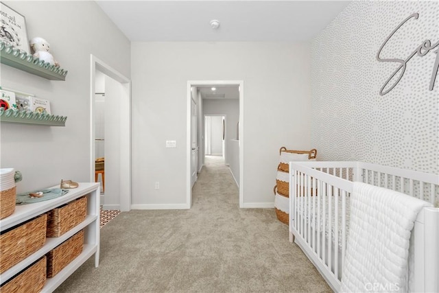 carpeted bedroom with a crib