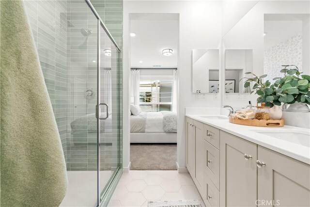 bathroom with tile patterned flooring, vanity, and an enclosed shower