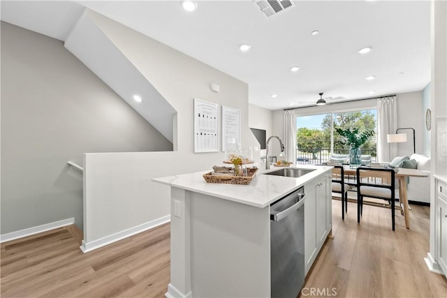 kitchen featuring sink, stainless steel dishwasher, an island with sink, light hardwood / wood-style floors, and white cabinetry