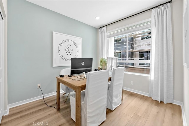 home office with light hardwood / wood-style floors