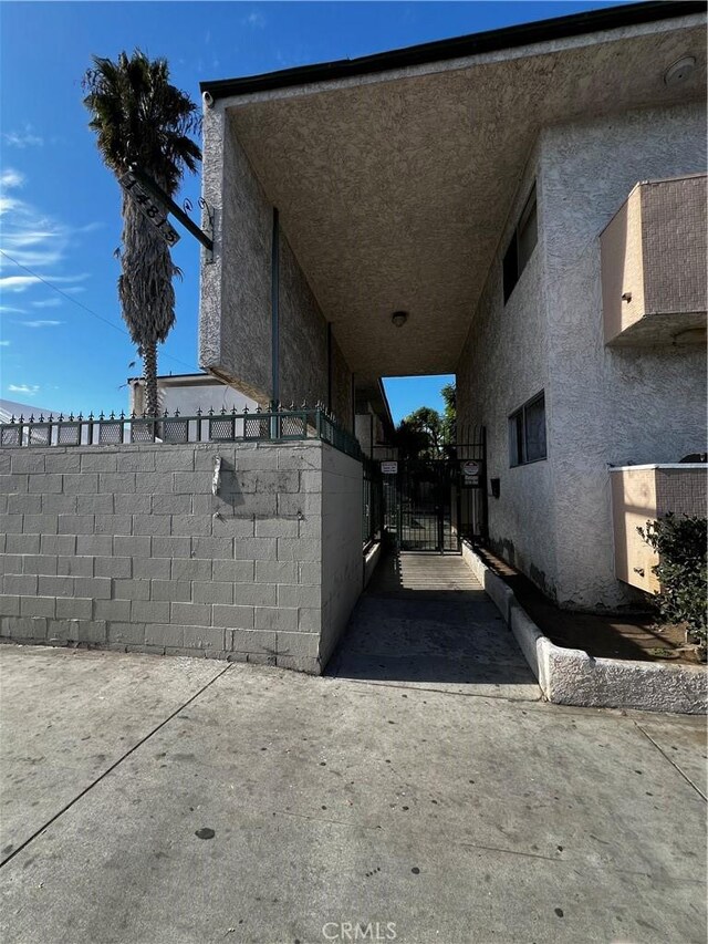 14815 Crenshaw Blvd, Gardena, CA 90249 - view of property exterior with a gate and stucco siding