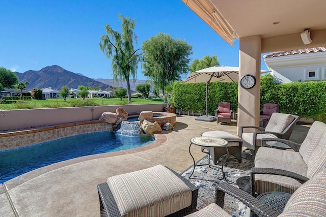 view of swimming pool with a mountain view, an in ground hot tub, and a patio