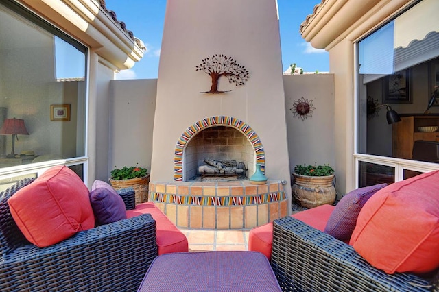 view of patio / terrace featuring exterior fireplace