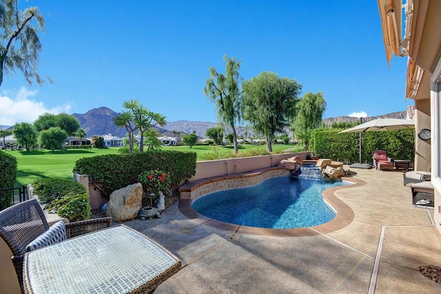 view of pool featuring a mountain view, a patio, and a lawn