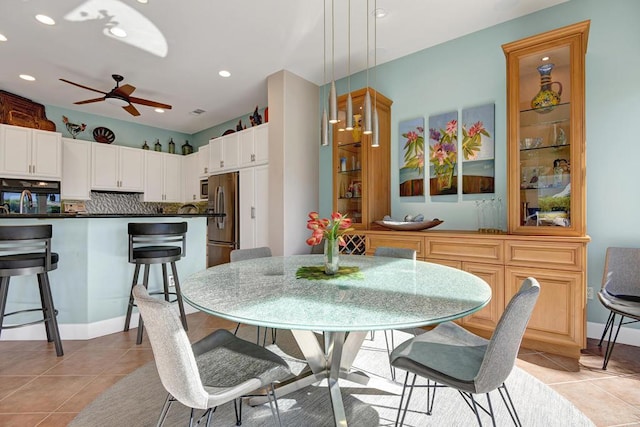 dining area with ceiling fan and light tile patterned floors