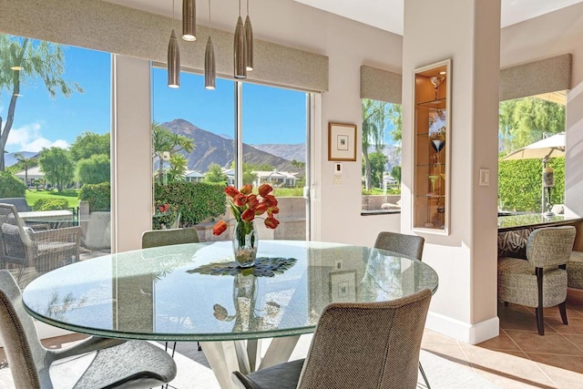 dining space with a mountain view and light tile patterned floors