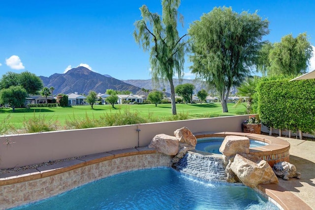 view of pool with a mountain view, an in ground hot tub, a yard, and pool water feature