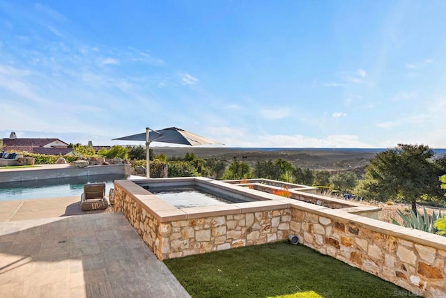 view of pool with an in ground hot tub