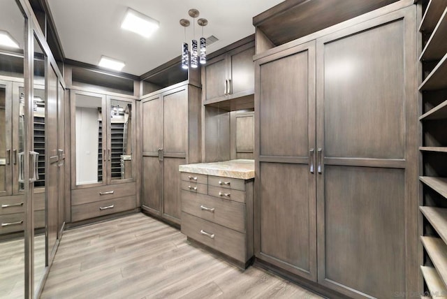 walk in closet featuring light hardwood / wood-style flooring