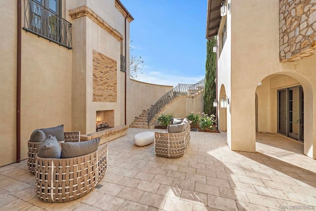 view of patio featuring an outdoor living space with a fireplace