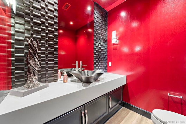 bathroom featuring hardwood / wood-style floors, vanity, and toilet