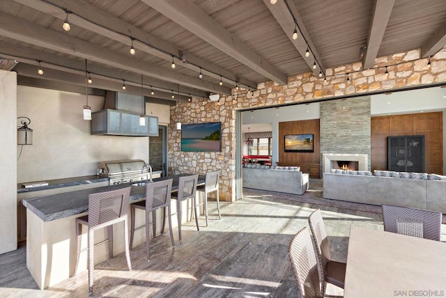 view of patio featuring exterior kitchen and an outdoor bar