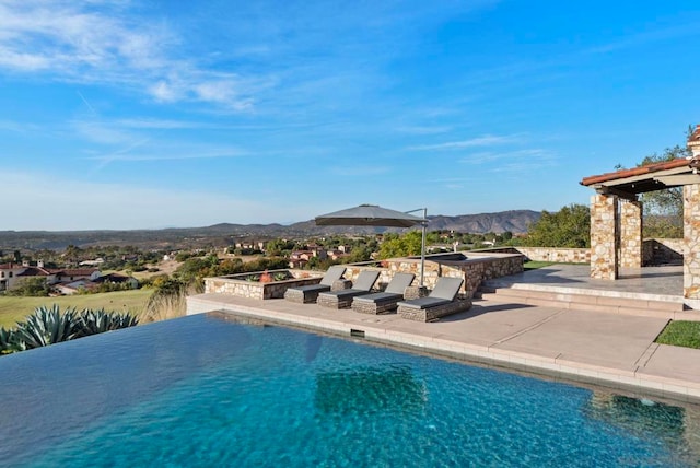 view of swimming pool with a mountain view