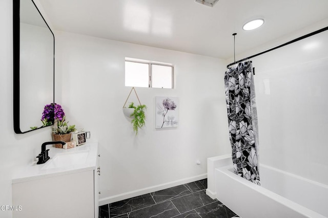 bathroom featuring shower / tub combo and vanity