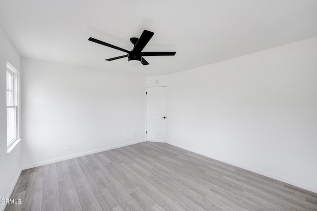 spare room with light hardwood / wood-style floors and ceiling fan