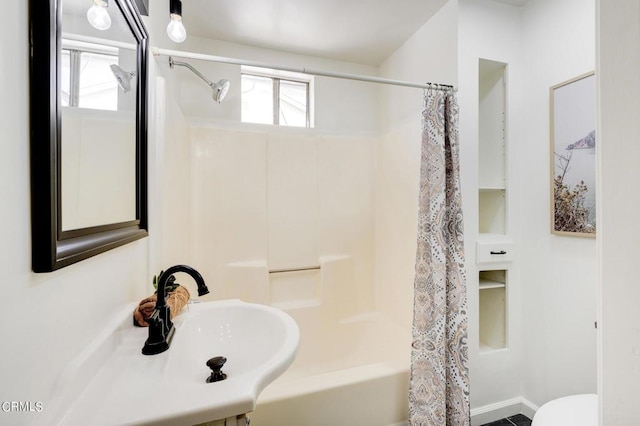 bathroom featuring shower / bath combo with shower curtain and toilet