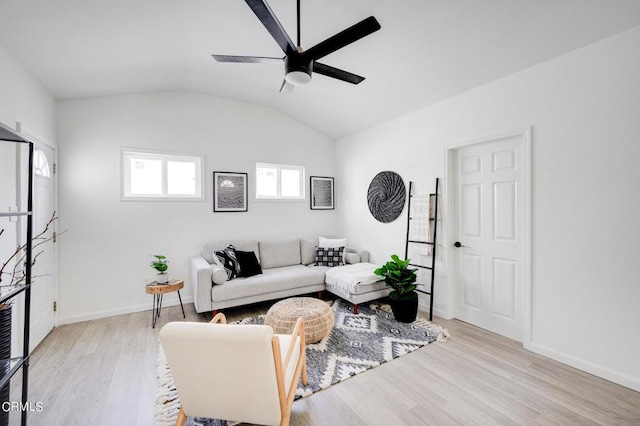 living room with light wood-type flooring, vaulted ceiling, and ceiling fan