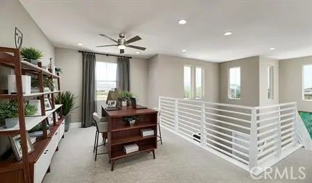 office with ceiling fan and light colored carpet