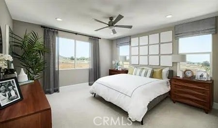 bedroom with ceiling fan and light carpet