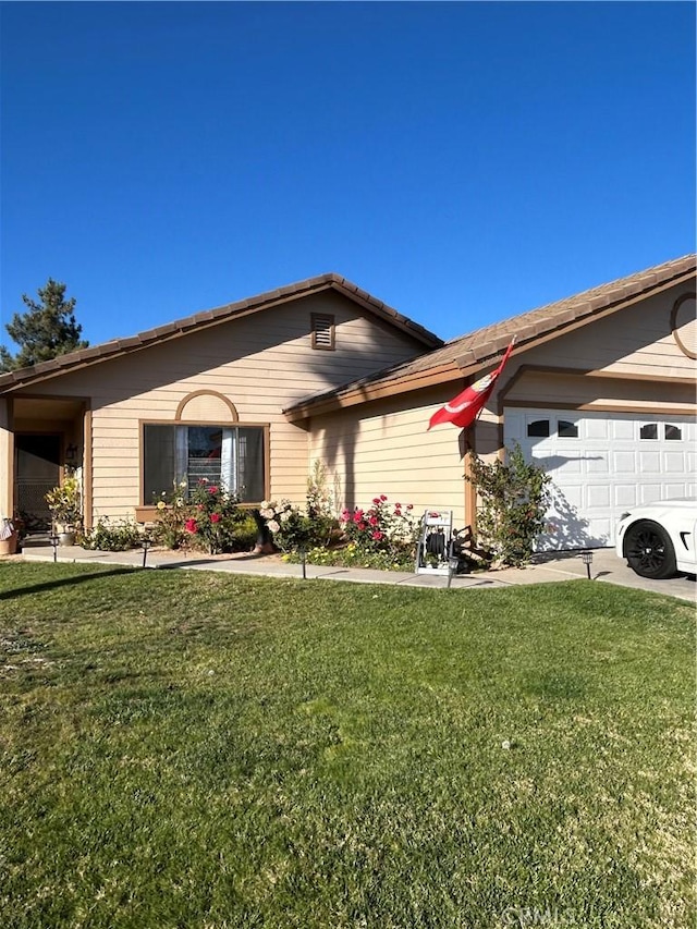 view of front of home with a garage and a front yard