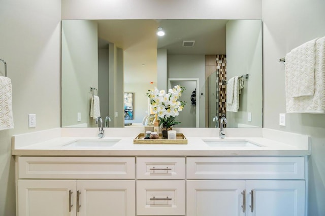 bathroom with vanity and a shower with door