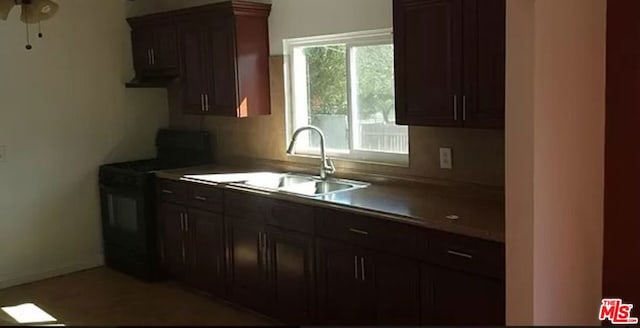 kitchen with electric range, ceiling fan, a healthy amount of sunlight, and sink