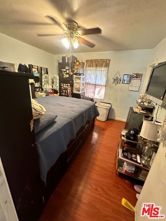 bedroom with ceiling fan and wood-type flooring