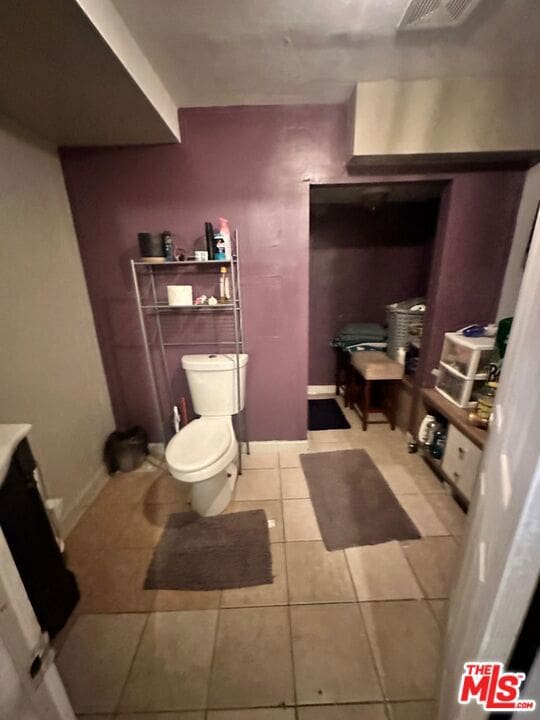 bathroom with toilet and tile patterned floors