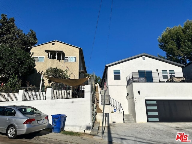 view of front of house featuring a balcony and a garage