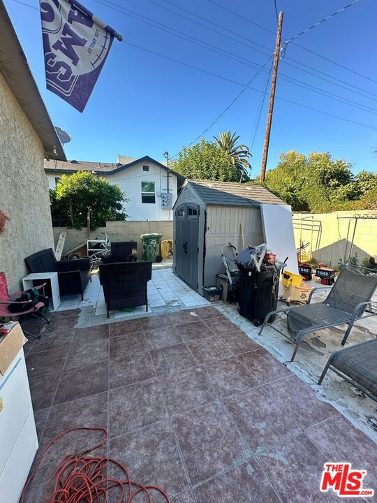 view of patio featuring a shed