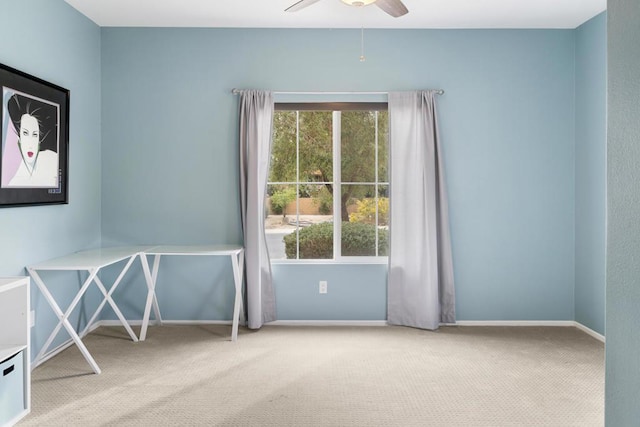 carpeted empty room featuring ceiling fan