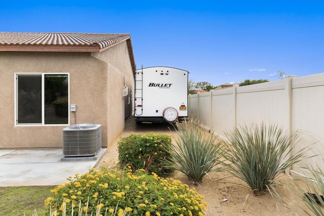 view of property exterior with a patio area and cooling unit