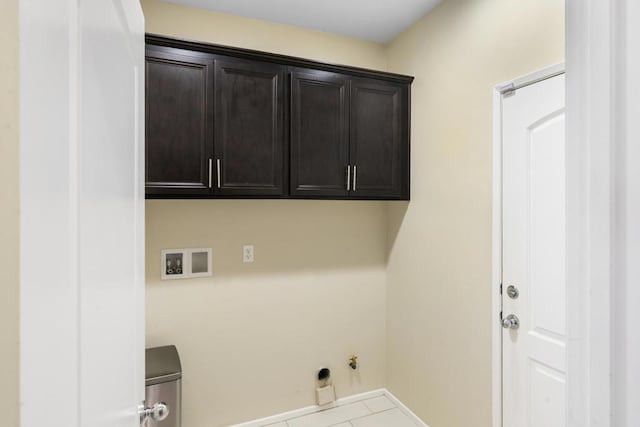 washroom with cabinets, washer hookup, light tile patterned floors, and gas dryer hookup