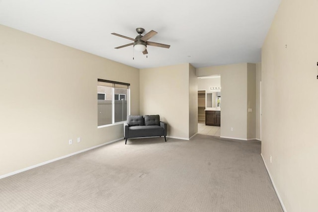 unfurnished room featuring ceiling fan and light colored carpet