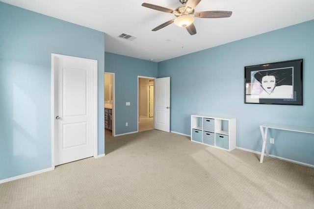 unfurnished bedroom with light carpet, connected bathroom, and ceiling fan