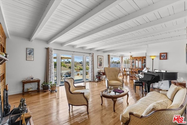 living room with beam ceiling, an inviting chandelier, light hardwood / wood-style flooring, and wood ceiling