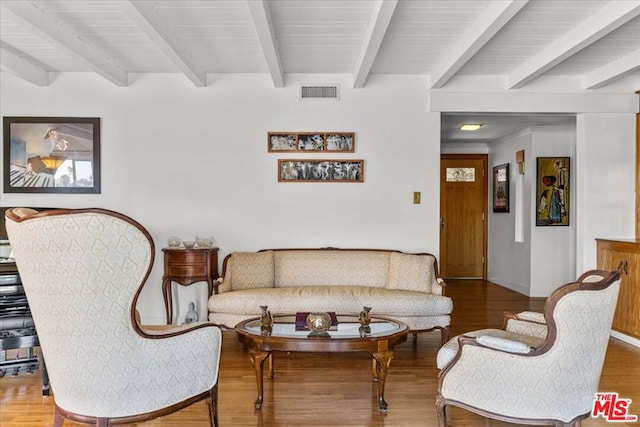 living room featuring hardwood / wood-style floors and beamed ceiling