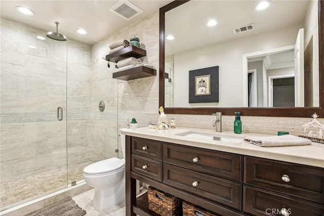 bathroom featuring backsplash, vanity, a shower with door, tile walls, and toilet