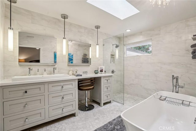 bathroom featuring vanity, tile walls, independent shower and bath, and a skylight